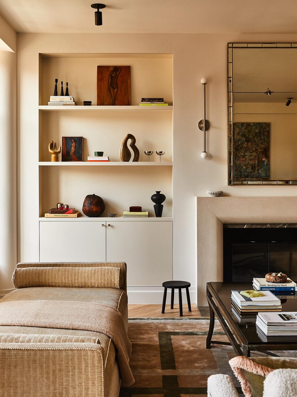 A living room with books and a fireplace